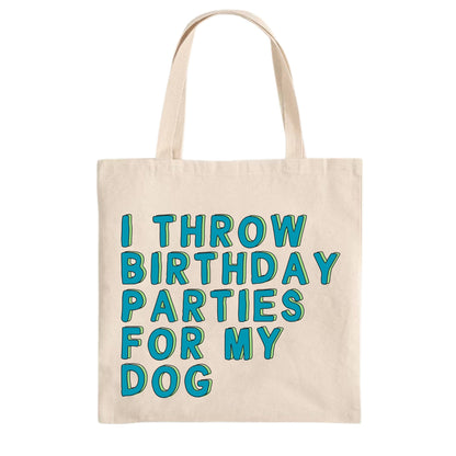 Beige tote bag with blue text 'I THROW BIRTHDAY PARTIES FOR MY DOG' on a white background