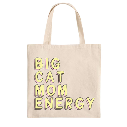 Beige tote bag with 'BIG CAT MOM ENERGY' text in yellow on a white background